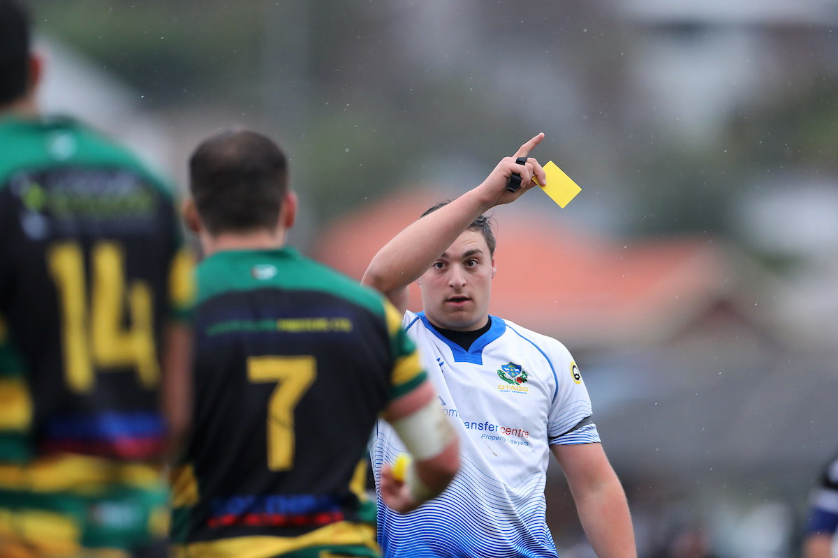 Referee Logan Whitty shows a yellow card during the Premier club rugby match between Kaikorai and Green Island played at Bishopscourt in Dunedin on Saturday 11th June, 2022. © John Caswell / http://www.caswellimages.com